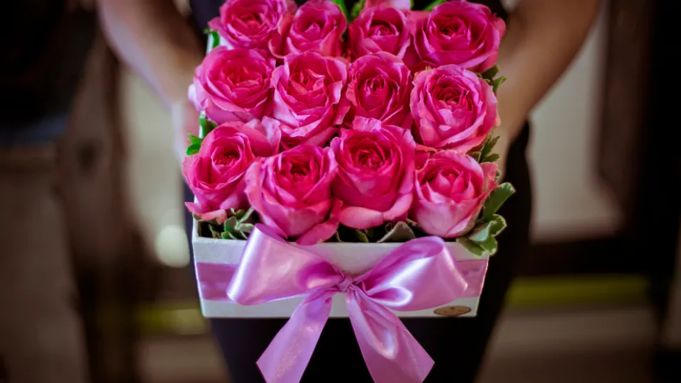 Roze rozen in een cadeaudoos met een strik